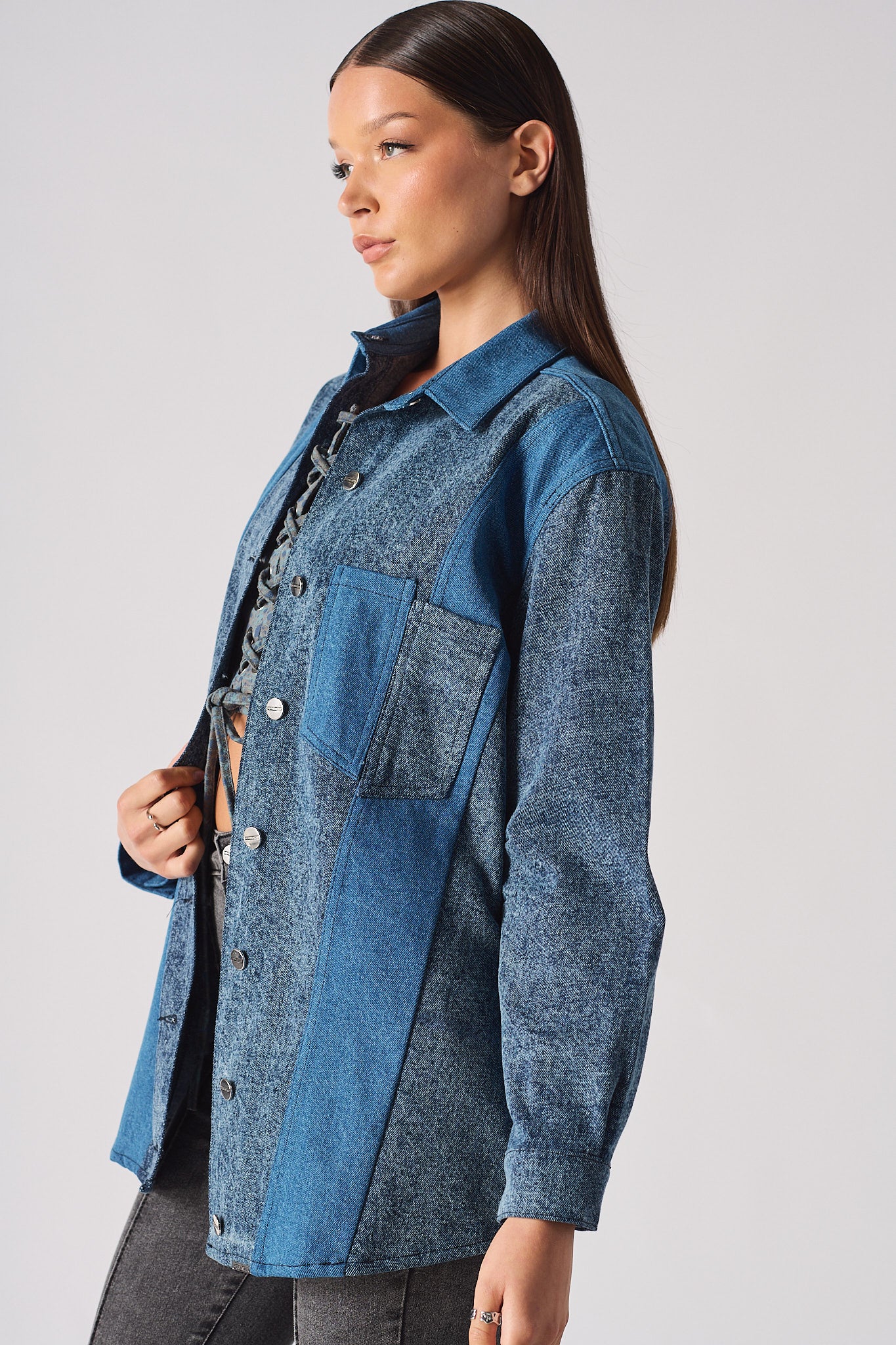 Back view of the women's contrast wash denim shirt laid flat.