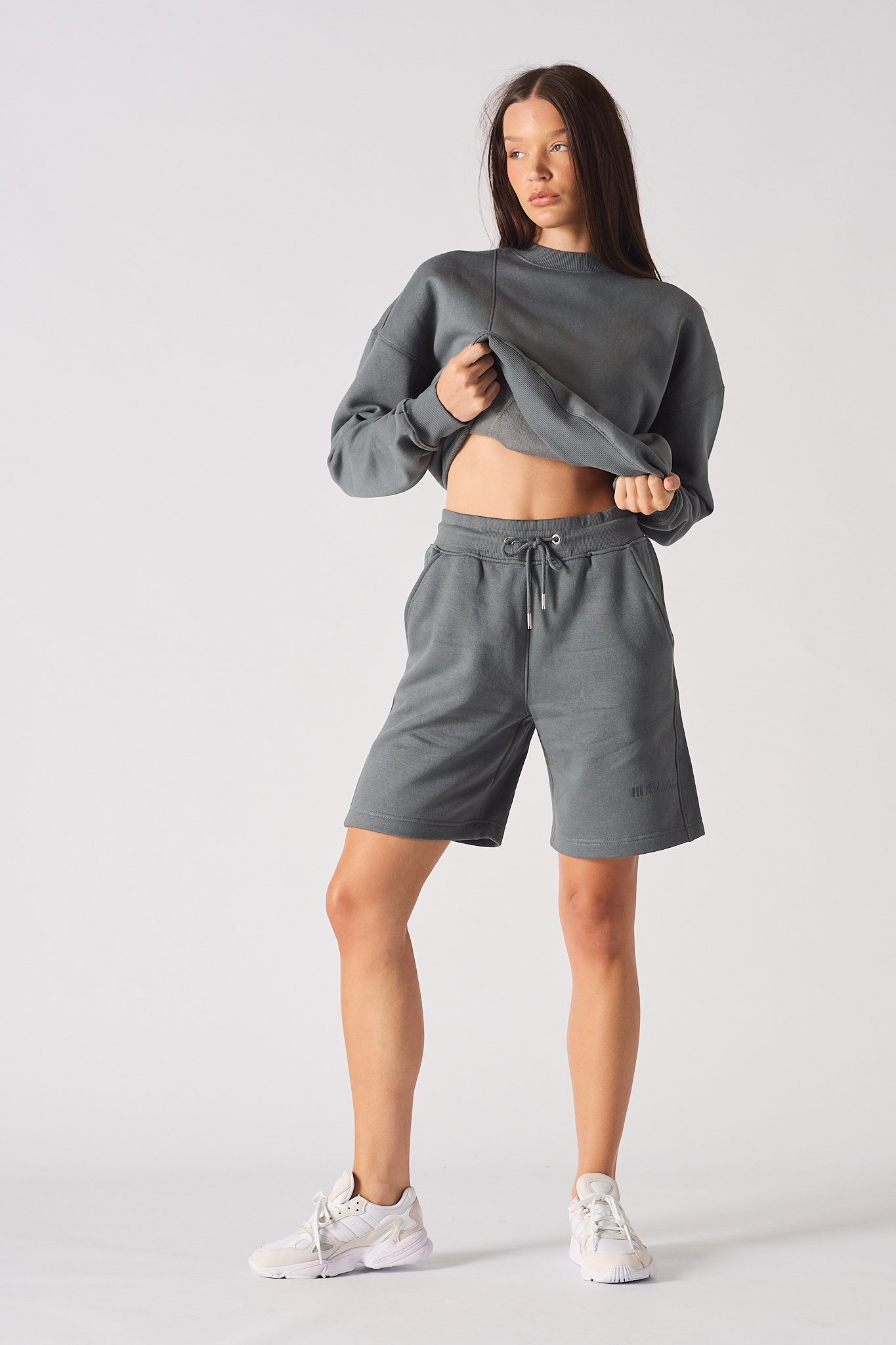 Front view of model wearing womens cool grey fleece shorts with matching sweatshirt