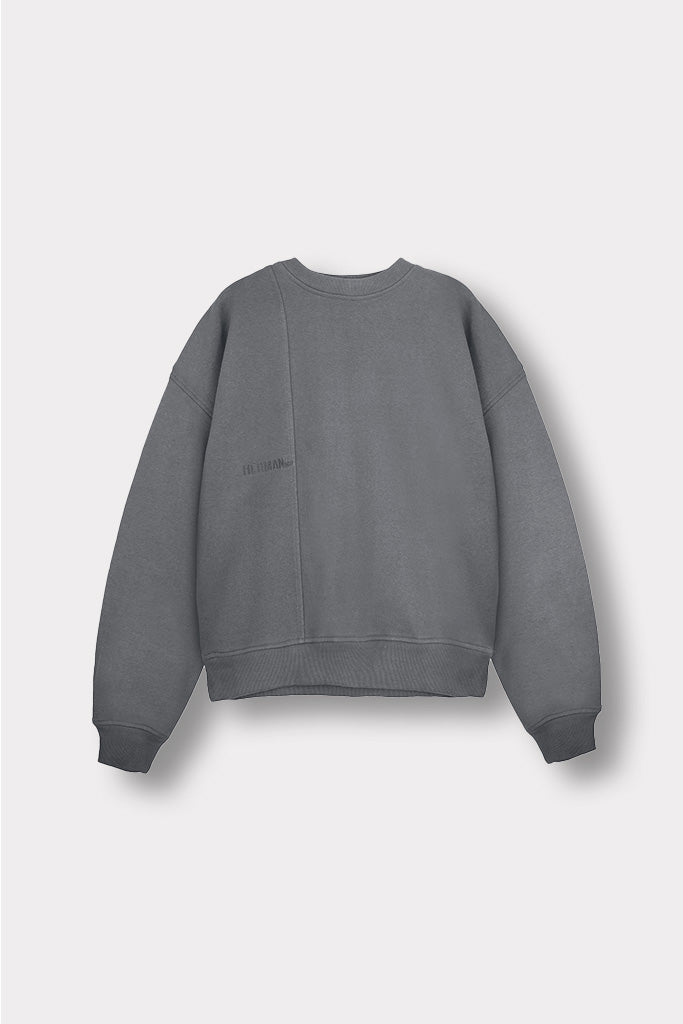 Close up of the ribbed hemline on women's cool grey crew neck jumper