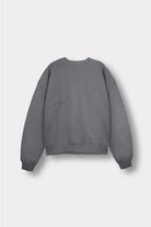 Close up of the ribbed hemline on women's cool grey crew neck jumper