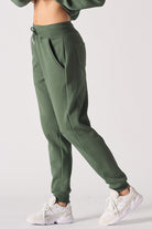 Side view of the women's dark green tapered joggers.