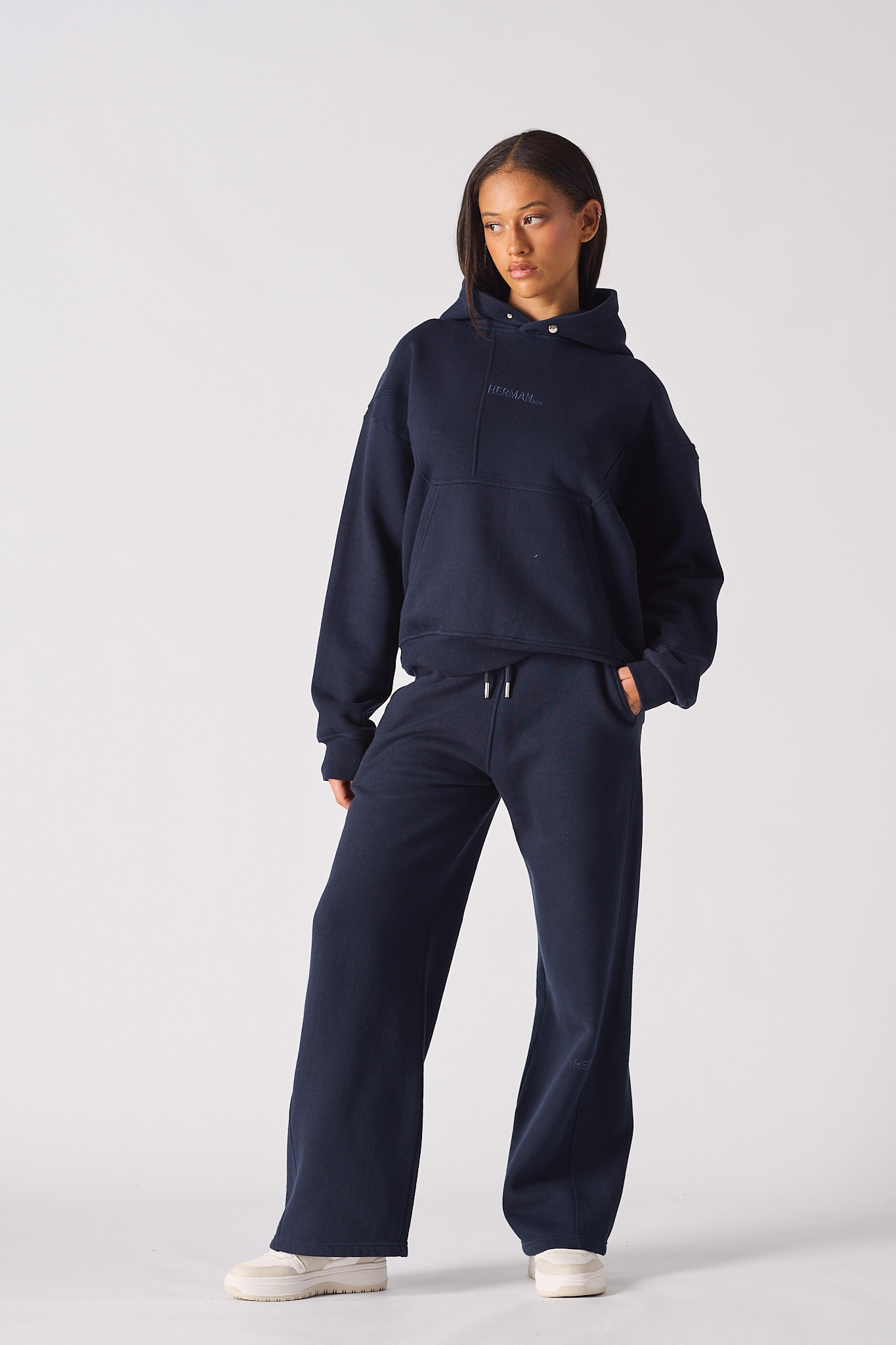 Woman wearing a dark navy hoodie women style with matching wide leg joggers