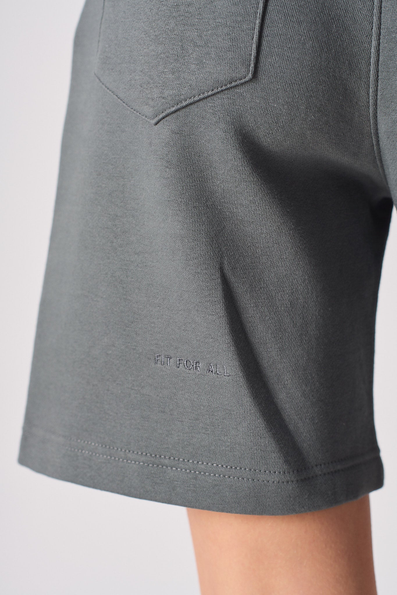 Close up view of the hem stitching on womens cool grey shorts