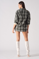 Back view of a model wearing the women's green checked overshirt.