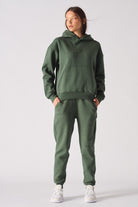 Close up texture view of the front pocket on dark green hoodie