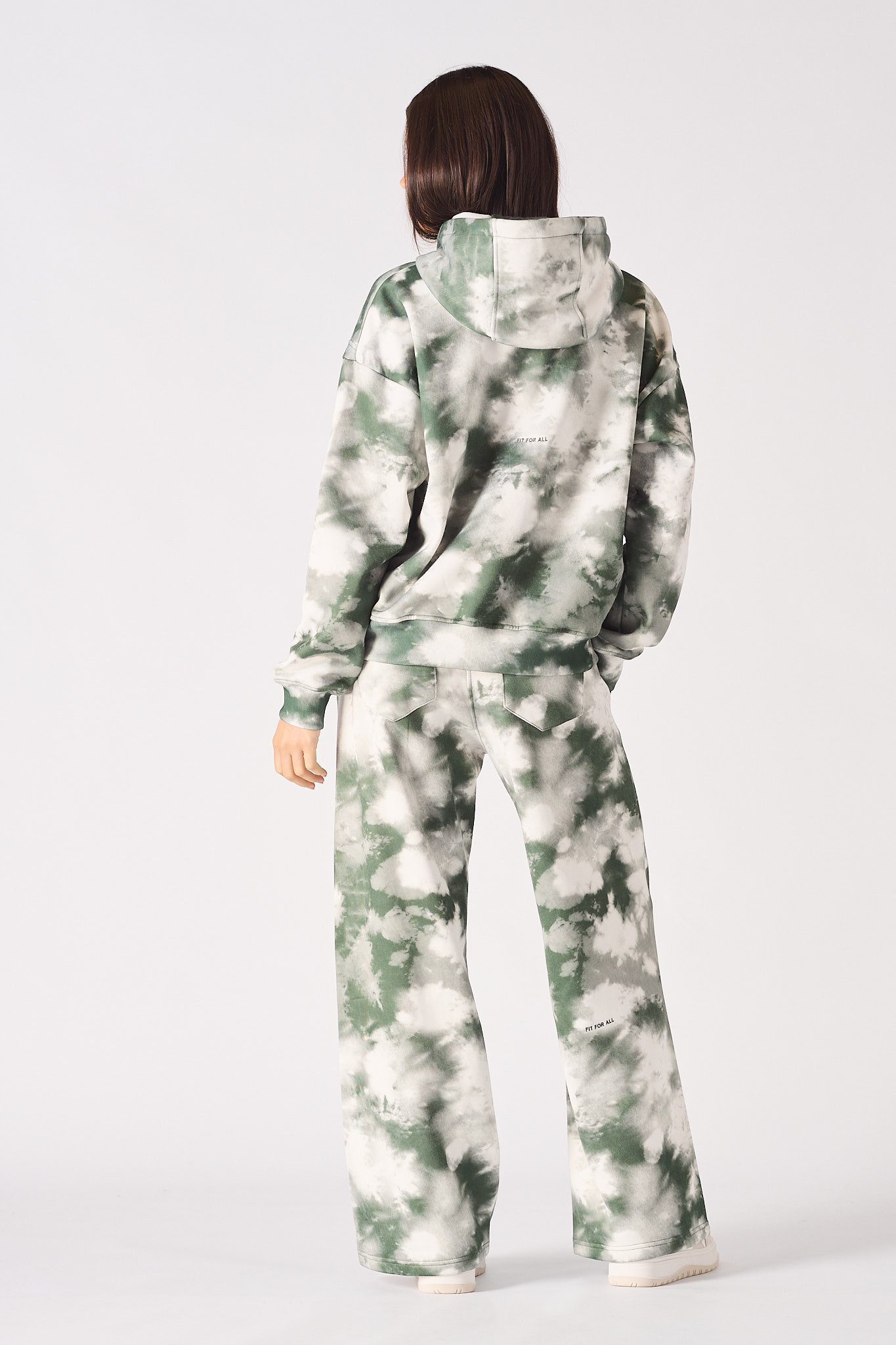 Rear full body view of womens tie dye dark green hoodie and joggers set