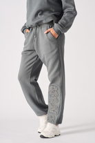Front close-up of the women's grey embroidered cuffed joggers.