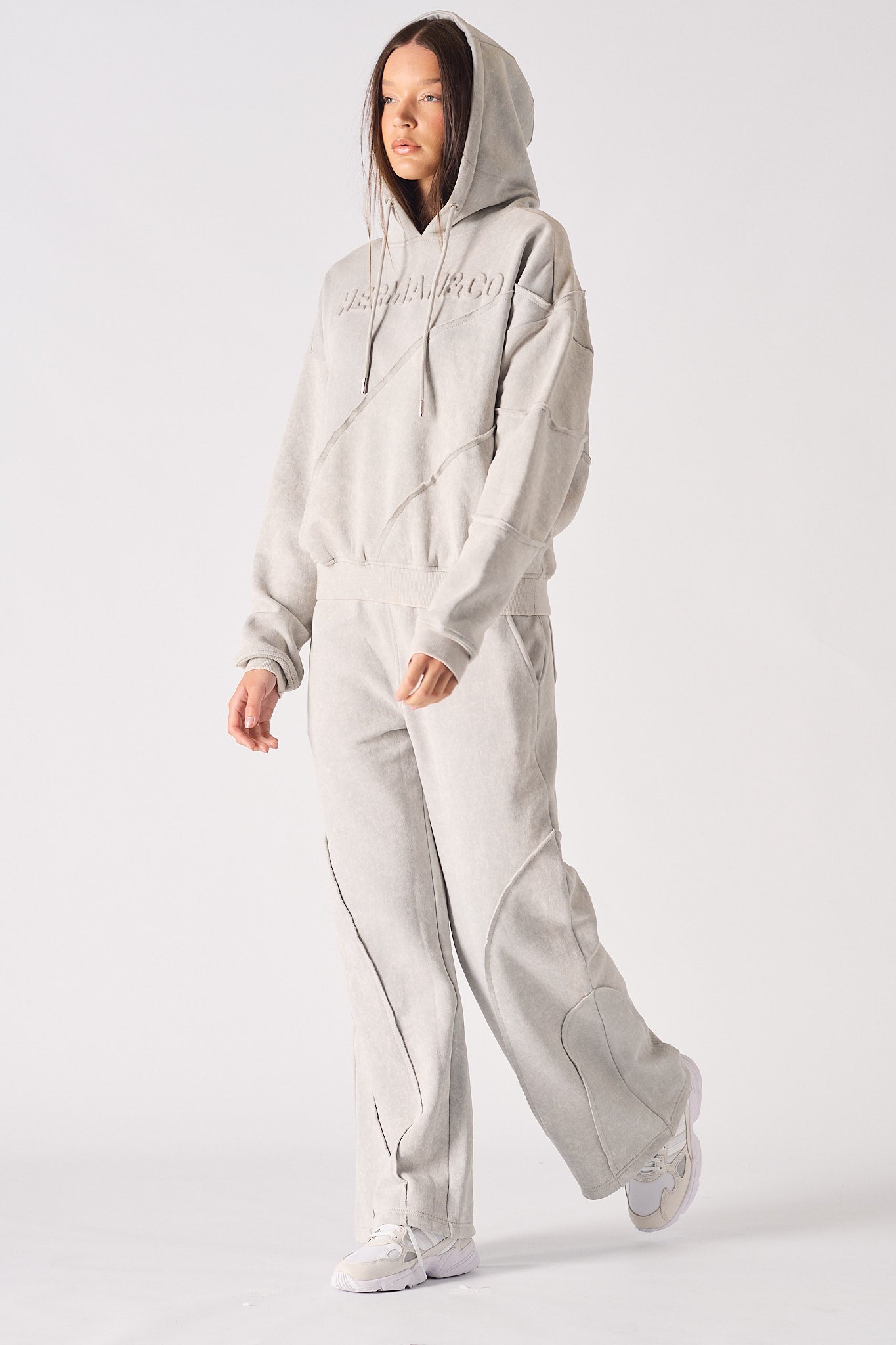 Model posing in a stylish womens oversized grey hoodie with a relaxed streetwear look