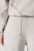 Close-up of the back pocket and seam detail on the women's grey joggers.