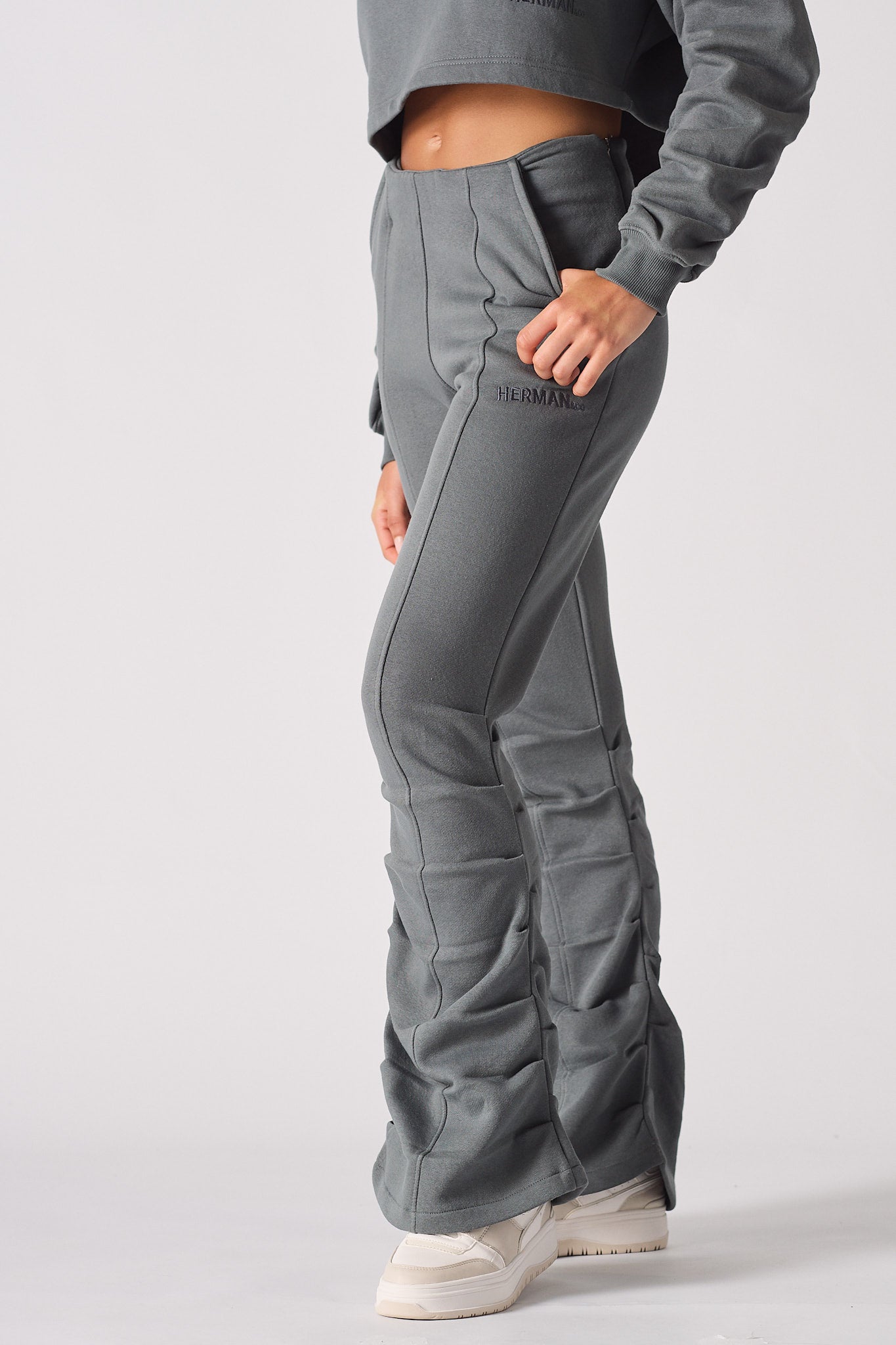 Close up side view of womens grey ruched joggers showing pocket detail