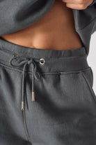 Extreme close up of the soft waistband texture on cool grey shorts