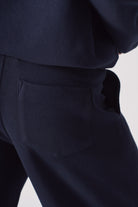 Close-up of the back pocket on the women's navy joggers.
