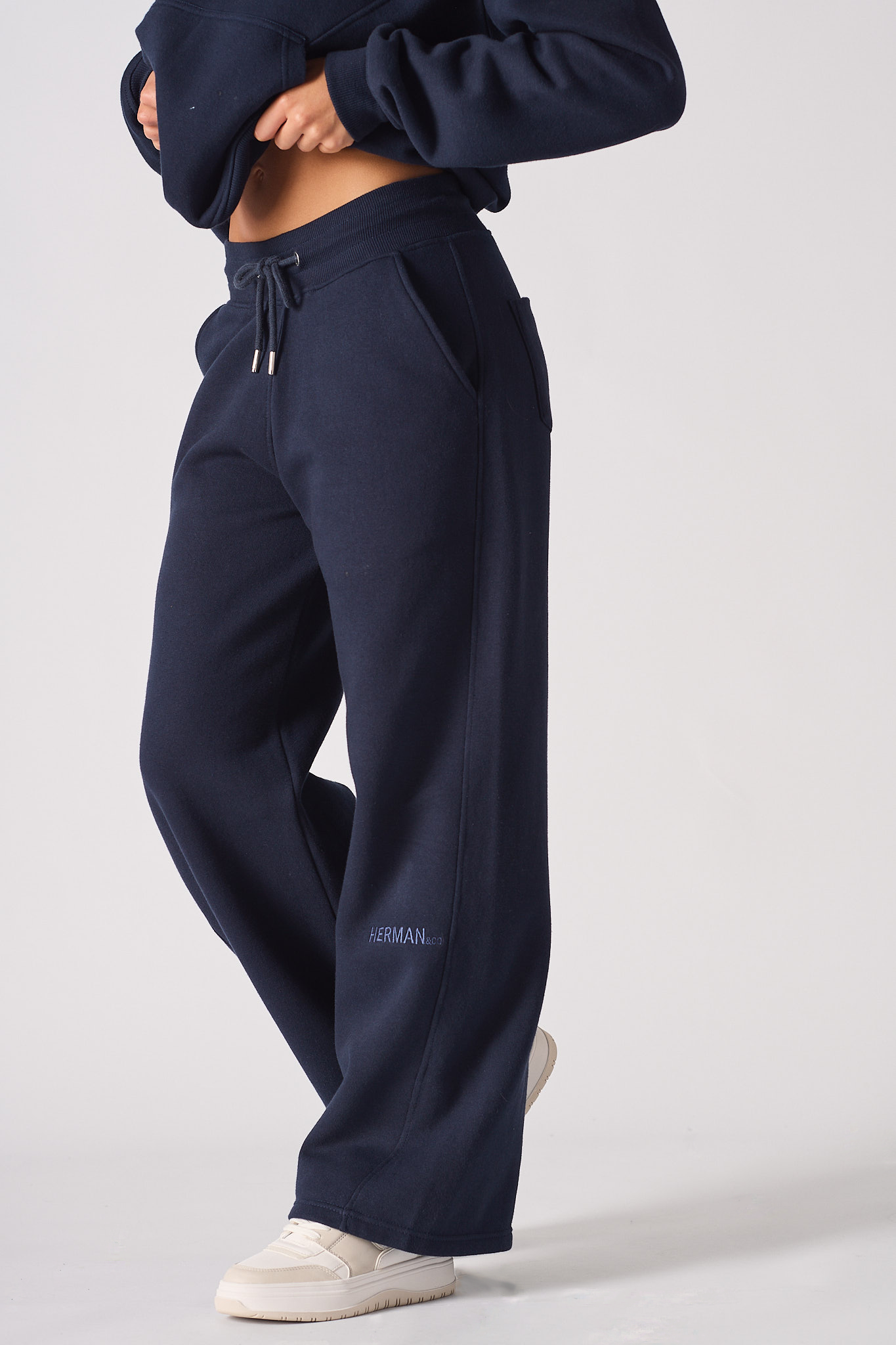 Side view close-up of the women's navy wide-leg joggers.