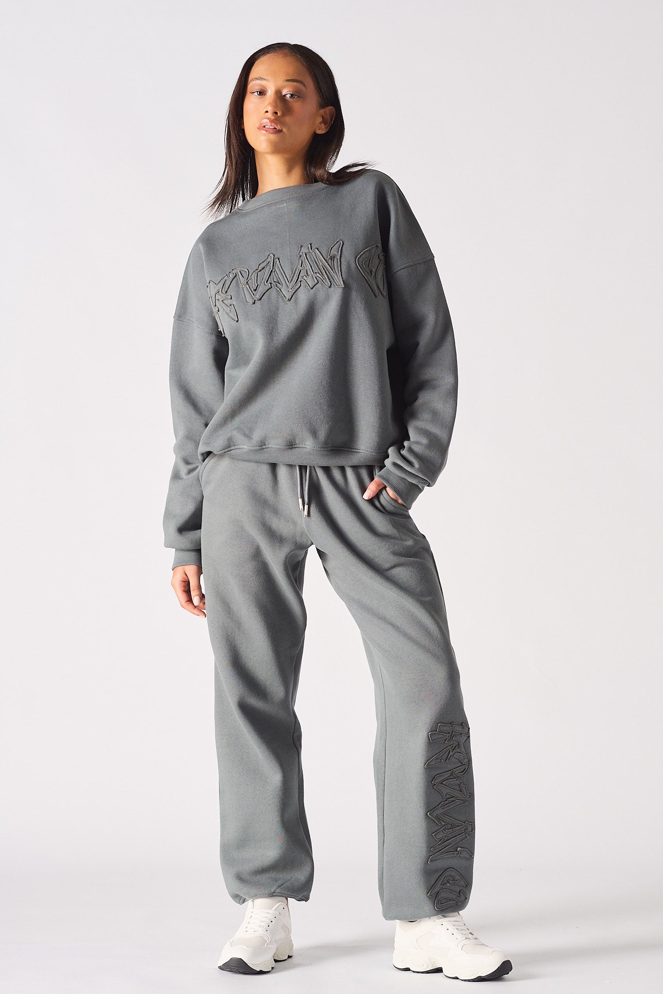 Front view of model wearing womens oversized grey sweatshirt with matching wide leg joggers