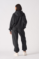 Model posing in a casual style wearing comfortable black oversized joggers