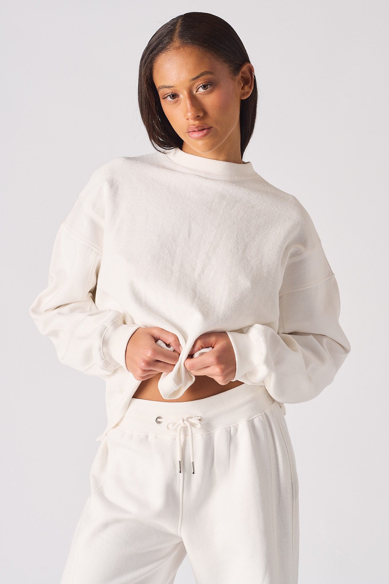 Portrait view of model wearing the essential white crew neck jumper womens