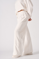 Side view of the women's white wide-leg joggers showing the relaxed fit.