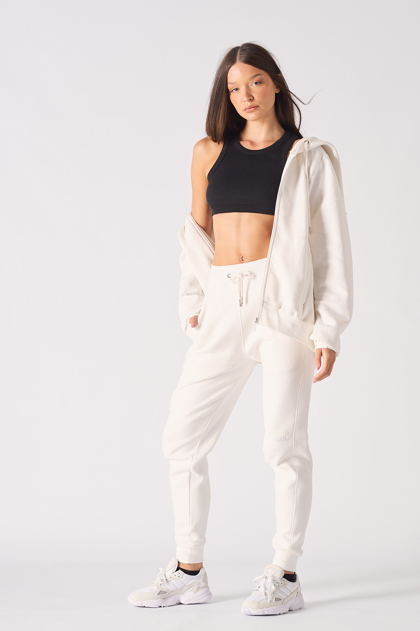 Full front view of a model wearing the women's white zip-up hoodie.