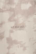 Close up detail of the abstract beige tie dye fabric pattern