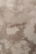 Close up texture view of the beige tie dye fabric and branding