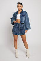 A full view of a model in the acid wash wide sleeve jacket and skirt.