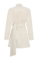 Back view of the asymmetric shirt for women in beige, laid flat.