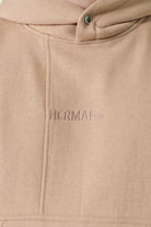 Detailed view of the kangaroo pocket on mens beige pullover hoodie