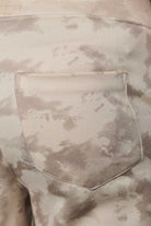 Detailed view of the back pocket on mens beige wide leg trousers