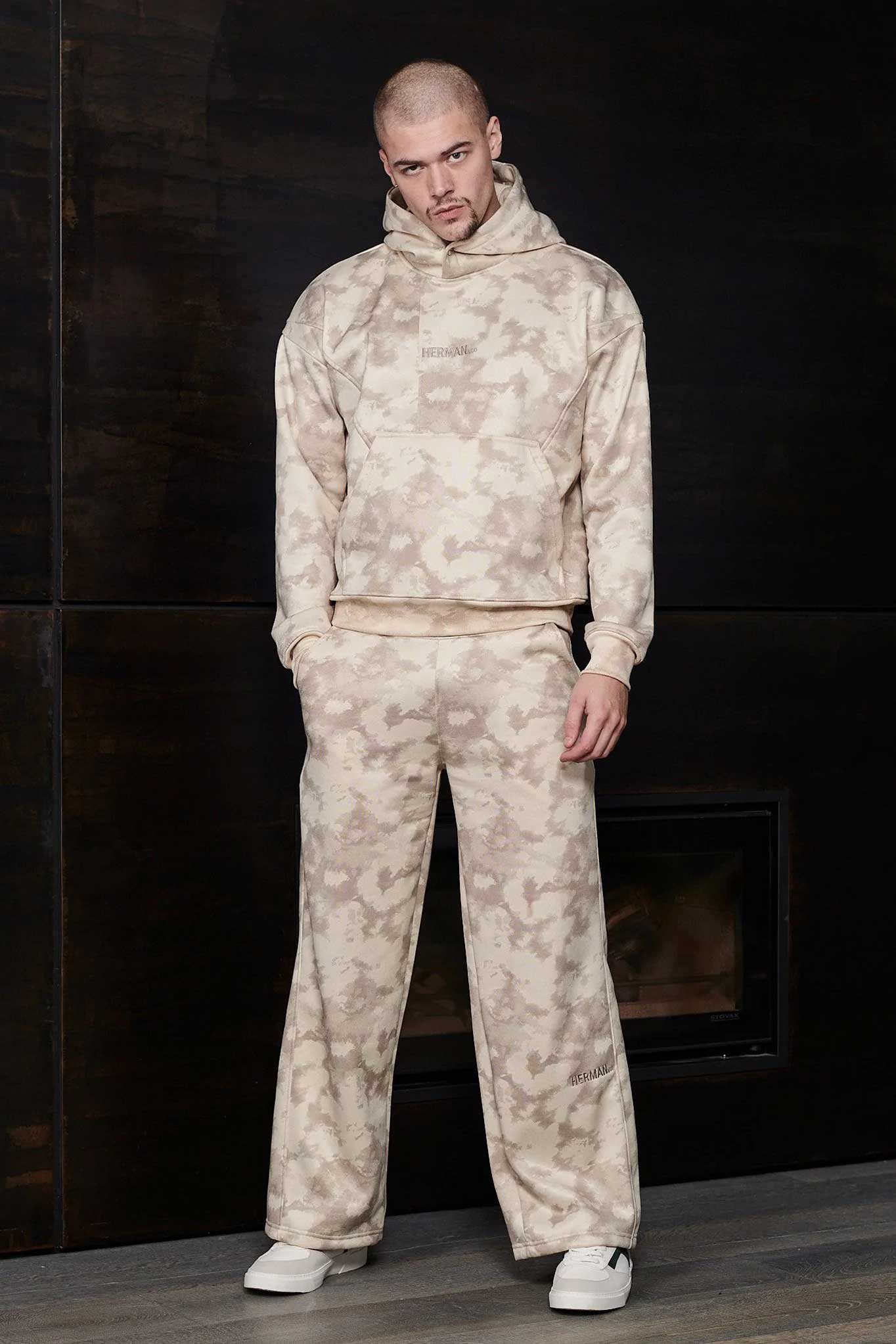 Model wearing the complete beige tie dye hoodie and wide leg jogger set