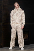 Model wearing the complete beige tie dye hoodie and wide leg jogger set