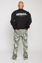 Back view of a model in the men's black crew neck jumper showing the large back print.