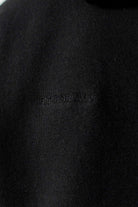 Detailed close up of the ribbed sleeve cuff on black zip up hoodie men