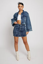 Model wearing the blue acid wash denim skirt with a matching cropped jacket.