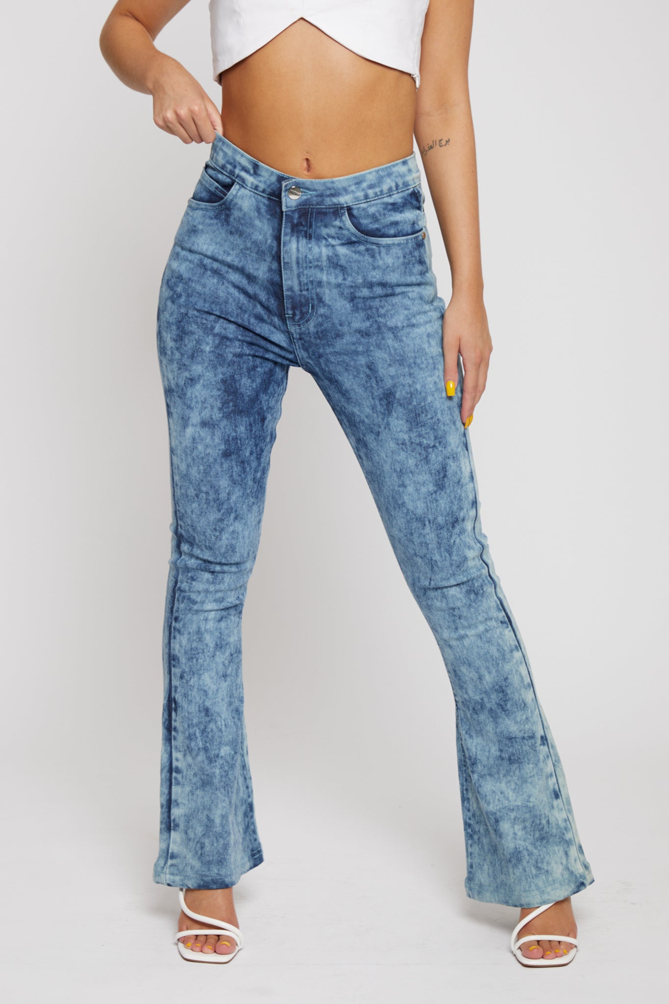 Close up front view of high-waisted blue acid wash jeans