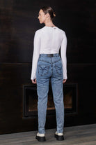 Back view of a model wearing the blue acid wash skinny jeans, showing pocket details