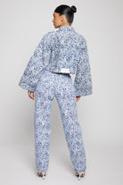 Back view of the blue marble print denim jacket and jeans set.