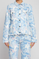 Close-up of the blue marble print and tapered waist detail on the denim jacket.