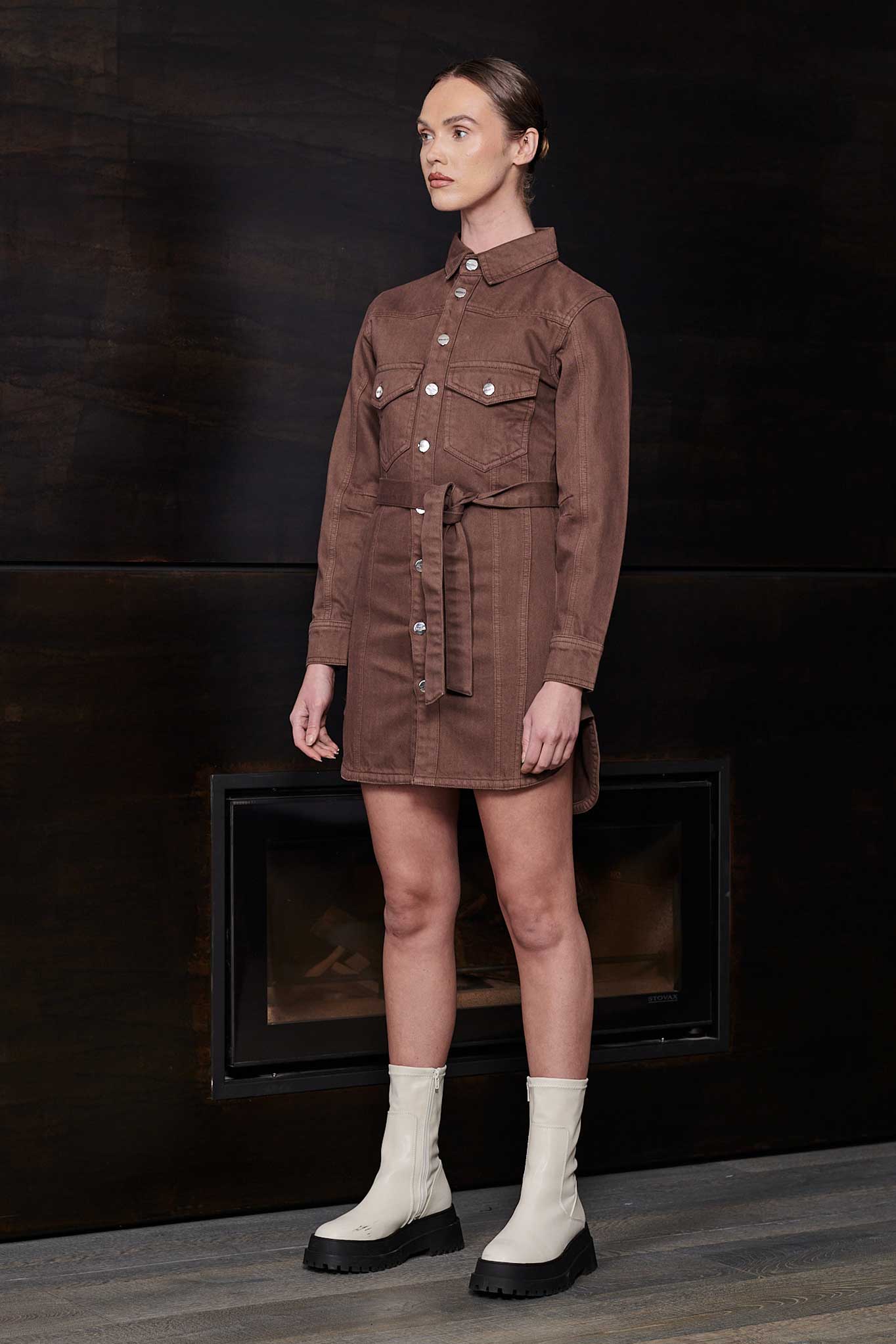 Side-angle view of a model in the brown denim shirt dress for women