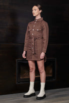 Side-angle view of a model in the brown denim shirt dress for women