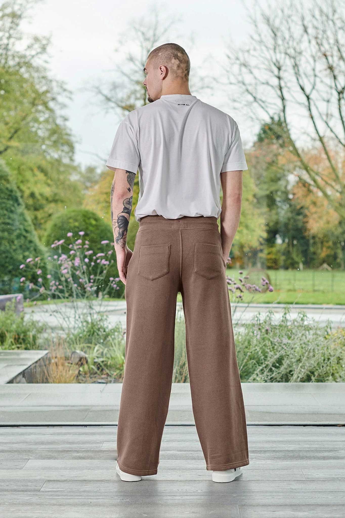 Back view of a model wearing the brown wide-leg joggers for men