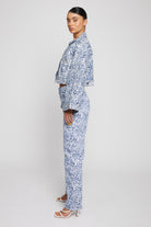 Side profile of the cropped marble denim jacket showing the flared sleeves.