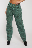 Close-up of the dark green acid wash baggy jeans with a wavy pattern.