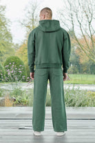 Rear view showing the relaxed fit of mens dark green hoodie