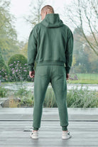 Rear view showing the relaxed tapered fit of mens dark green joggers