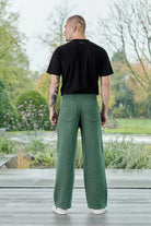 Back view of a model in the dark green wide-leg joggers