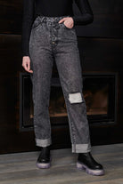 Detailed view of the dark grey acid wash fabric and texture