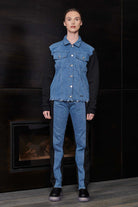 A model wearing the denim and fleece jacket for women with matching bottoms.