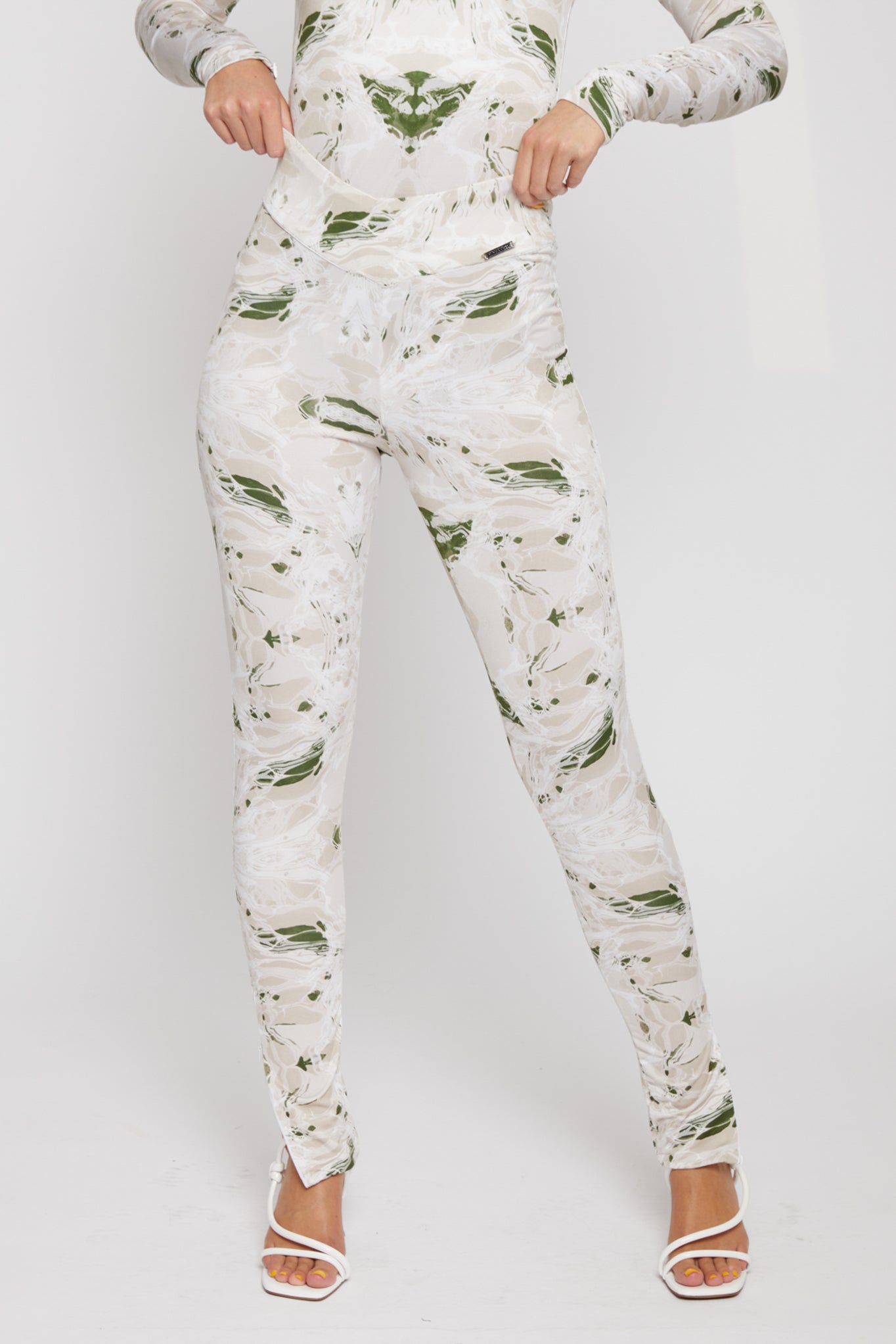 Close-up of the dipped waist leggings showing the intricate print and v-shape waistband.