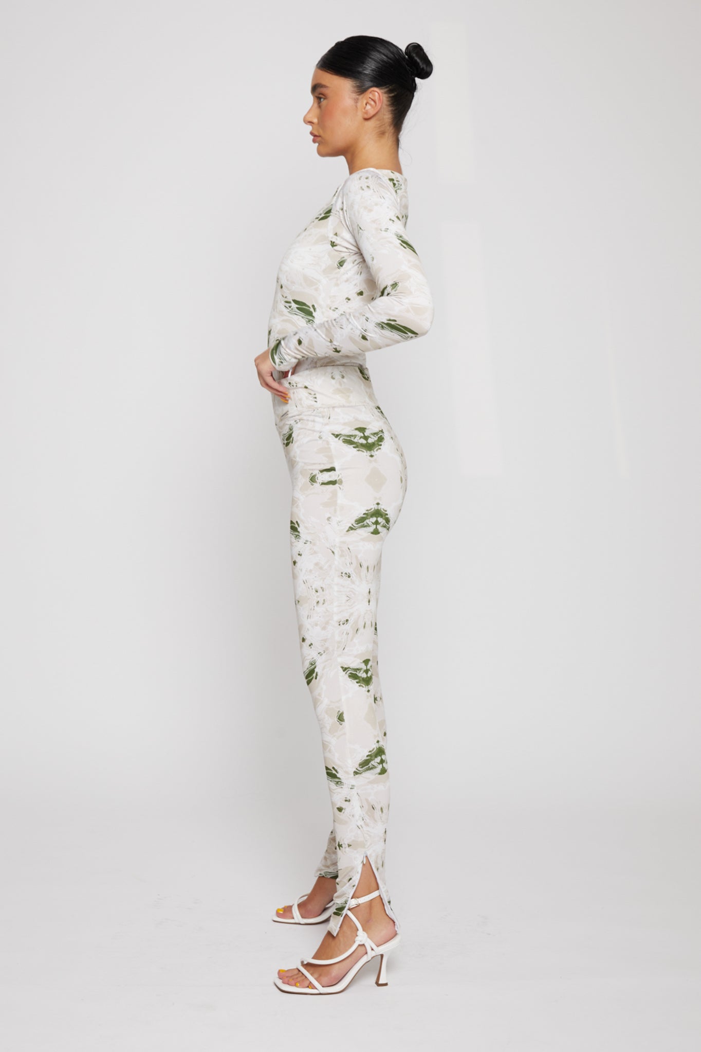 Side profile of a model showing the fit of the dipped waistband leggings.