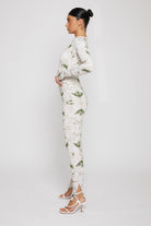 Side profile of a model showing the fit of the dipped waistband leggings.